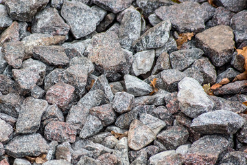A pile of gravel with autumn leaves