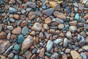 Multi colored beach stones on the shore of Lake Superior, background, texture