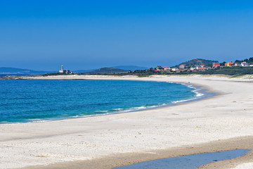 Pristine white sandy beach and blue ocean in Muros, Galicia, Spain.