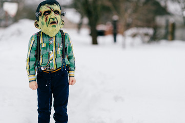 Funny helloween children in creepy horror silicon masks portrait. Little comical kids with horrible...