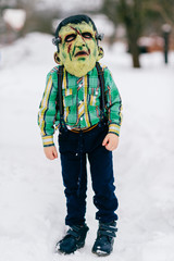Funny helloween children in creepy horror silicon masks portrait. Little comical kids with horrible...