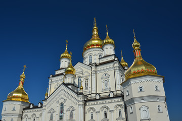 Fototapeta na wymiar Religious building, Orthodox Christian cathedral with golden domes. Transfiguration Cathedral, Holy Dormition Pochayiv Lavra in Ukraine.