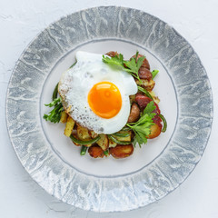 Fried potato topped with sunny side egg