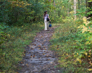 Young woman relaxing, walking in forest preserve park
