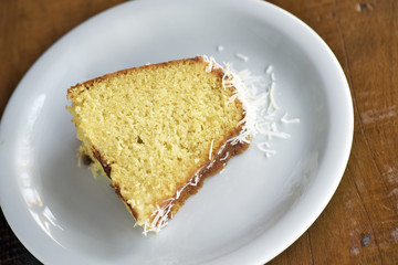 Slice of homemade cake with coconut flakes