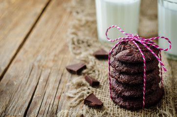 Chocolate brownie cookies with glasses of milk