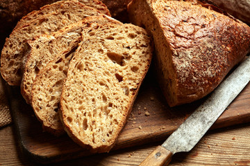 fresh baked bread slices on wooden background