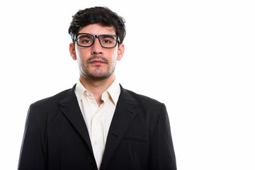 Studio shot of young Persian businessman wearing eyeglasses