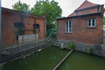 old brick house with a small private  dam