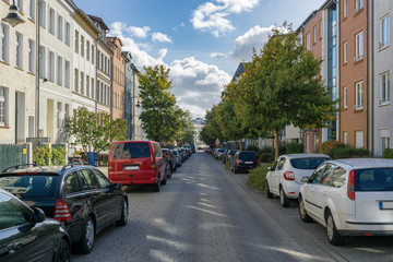 Fototapeta na wymiar street view of an avenue in rostock - parked cars at the side
