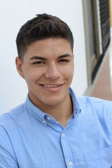 Young hispanic male wearing blue button up