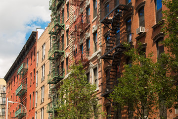 Old colorful buildings with fire escape in Little Italy, New York City, USA