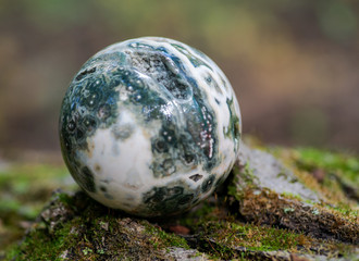 Orbicular ocean jasper sphere with crystallized vugs from Madagascar on moss, bryophyta and bark,...