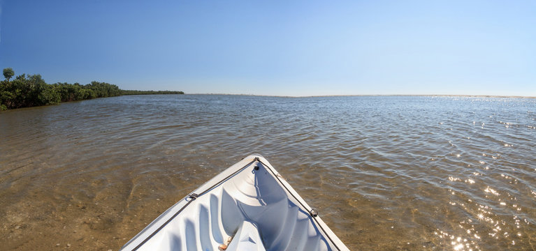 Kayak glides through water along the coastline of Marco Island, Florida