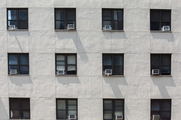 front of an old office building with air conditions hanged on windows, Manhattan, New York