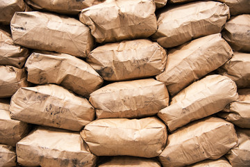 Kraft bags with charcoal for igniting a fire for a barbecue or grilled dishes. bags of coal on the supermarket showcase. a pile of paper bags. barbecue season