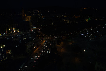 Aerial night view of a city and traffic of cars. Malaga, Spain
