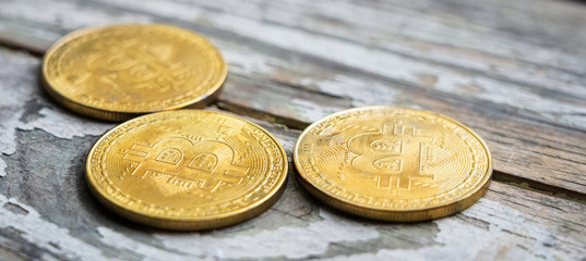 Gold Bitcoin money on wooden table. Electronic crypto currency