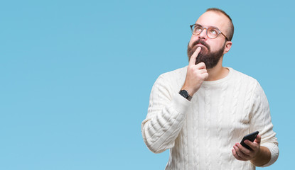 Young caucasian hipster man texting sending message using smartphone over isolated background...