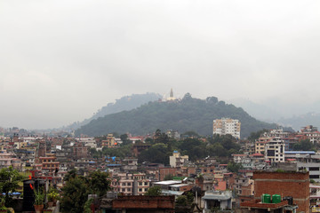 The view of Swayambhunath Stupa from the rooftop in Kathmandu during cloudy day