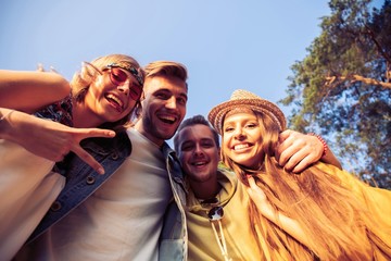 Fototapeta premium A group of young people friends make selfies outside. Summer, vacation, fun, friendship concept