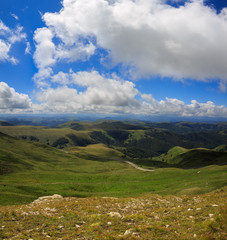 Fototapeta premium Clouds over the hills in the area of Mount Elbrus. Photographed in the Caucasus, Russia.