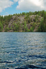 craggy rocks covered with forest over North lake
