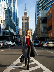 beautiful blonde walks in the city - obrazy, fototapety, plakaty