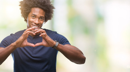 Afro american man over isolated background smiling in love showing heart symbol and shape with...