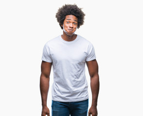 Afro american man over isolated background puffing cheeks with funny face. Mouth inflated with air, crazy expression.