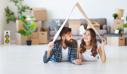 happy young married couple moves to new apartment