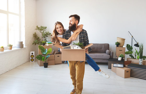 happy young married couple moves to new apartment