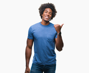 Afro american man over isolated background smiling with happy face looking and pointing to the side...