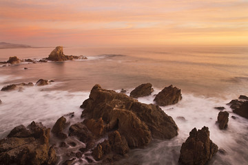 nugget point jets rocks out into the Pacific ocean during a sunrise