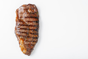 grilled marbled beef steak striploin isolated on white background, top view with copy space