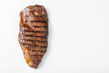 Naklejka premium grilled marbled beef steak striploin isolated on white background, top view with copy space
