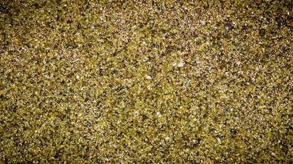 Macro of the green sand at Papakolea Green Sand Beach near the South Point of Big Island, Hawaii.