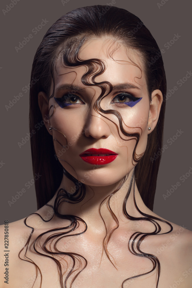 Wall mural portrait of beautiful woman. fantasy make-up. wet hairs on her face and body.