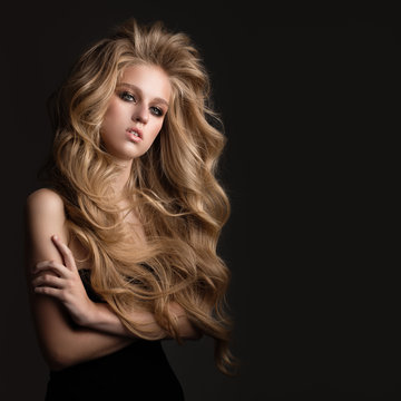 Beautiful woman with blond curly hair. Hairstyle.