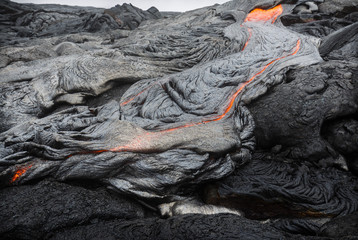 Molten magma breaking through the ground of the lava fields of Puu Oo, Big Island, Hawaii.