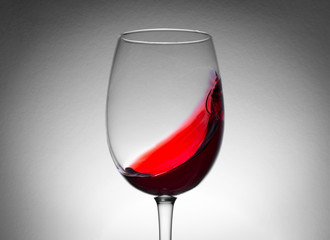 Red wine splash in the wineglass close-up macro texture background. Vintage old retro style view. Soft focus.