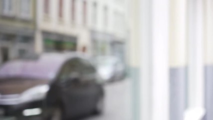 Out of focus blurry background plate of city street with cars passing