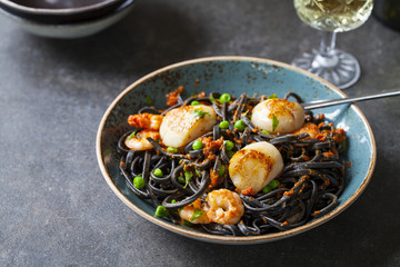 Squid ink pasta with prawns and scallops