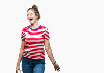 Fototapeta premium Beautiful brunette curly hair young girl wearing casual look over isolated background winking looking at the camera with sexy expression, cheerful and happy face.