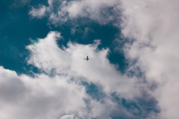 sun and cumulus white clouds against a beautiful blue sky, fly plane