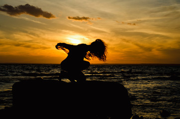 silhouette of a young woman with a good figure at sunset