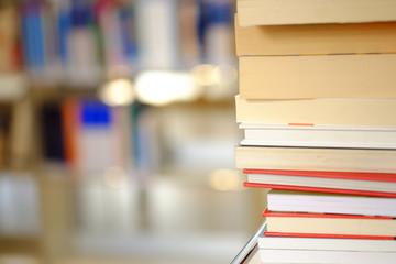 Stack of books on a shelf in a library