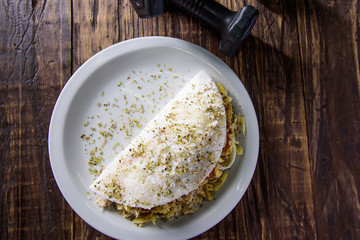 Delicious Tapioca, a brazilian snack made with cassava flour and stuffed with chicken, tomatos and cheese