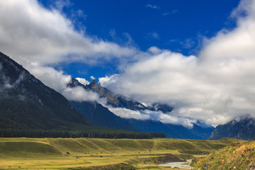 Fototapeta premium Clouds over the rocky ridge of the mountainous region of the North Caucasus in Russia.