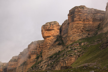 Clouds over the rocky ridge of the mountainous region of the North Caucasus in Russia.